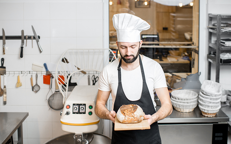 baker with bread in the bakery 2023 11 27 05 16 05 utc